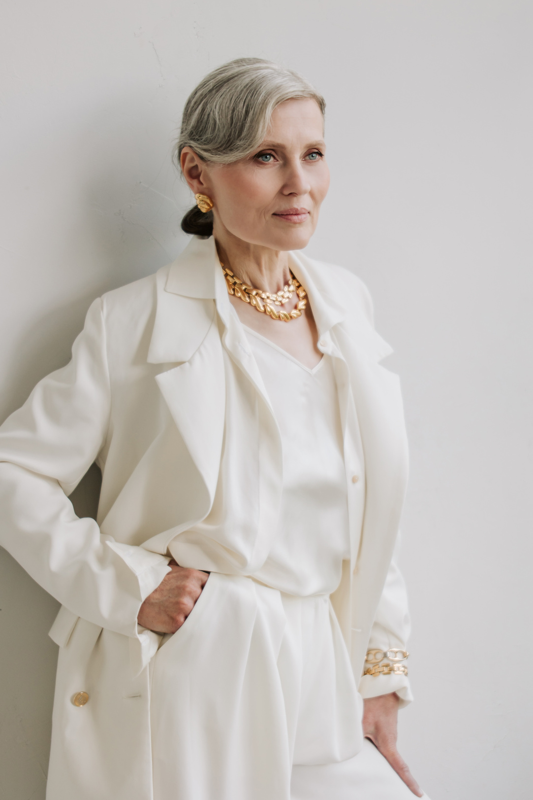 Portrait of Senior Woman in White Outfit with Gold Jewelries